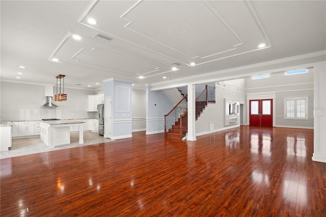 unfurnished living room featuring light hardwood / wood-style floors and crown molding