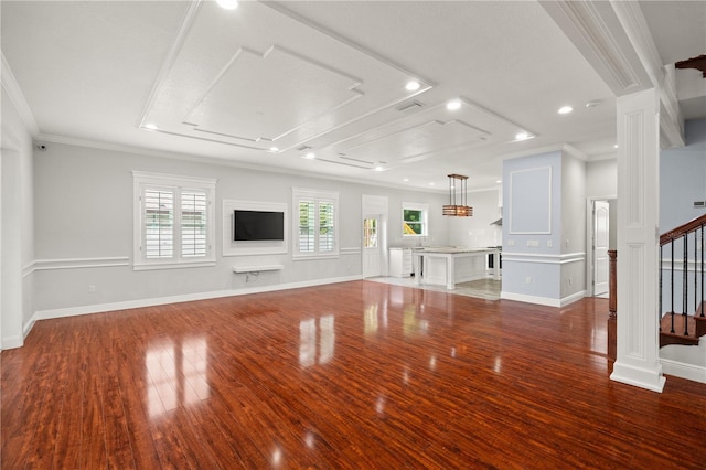 unfurnished living room featuring wood-type flooring and crown molding