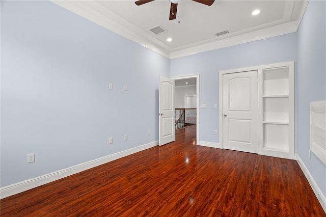 unfurnished bedroom featuring a closet, dark wood-type flooring, ceiling fan, and ornamental molding