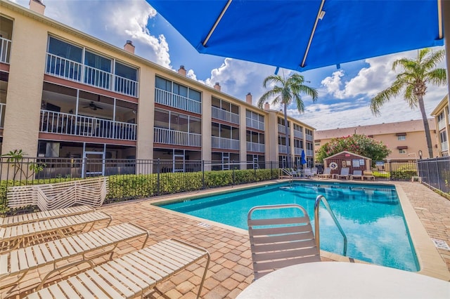 view of swimming pool featuring ceiling fan