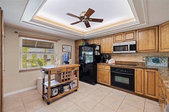 kitchen with black appliances, tasteful backsplash, ceiling fan, light tile patterned floors, and a raised ceiling