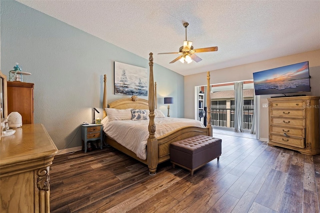 bedroom with access to outside, dark hardwood / wood-style flooring, vaulted ceiling, ceiling fan, and a textured ceiling