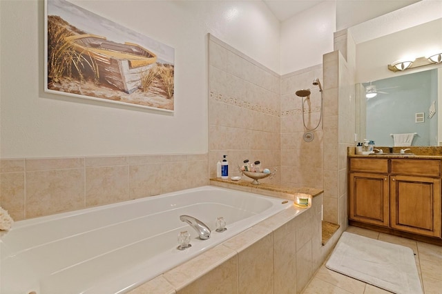 bathroom with tile patterned floors, separate shower and tub, and vanity