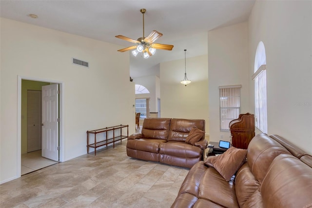 living room with high vaulted ceiling, ceiling fan, and plenty of natural light