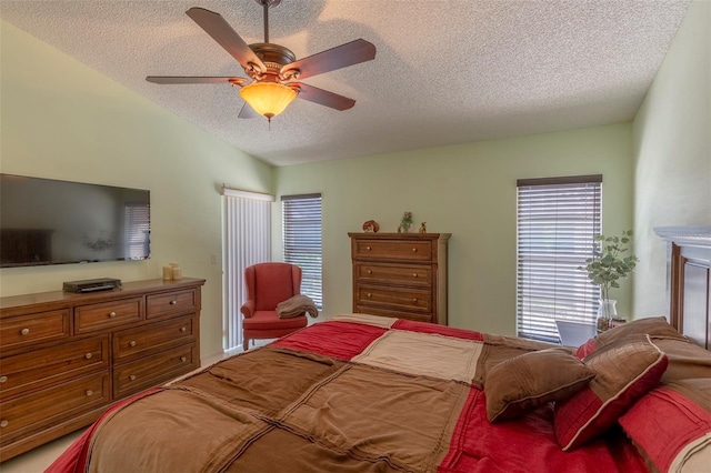 bedroom featuring a textured ceiling, vaulted ceiling, and ceiling fan