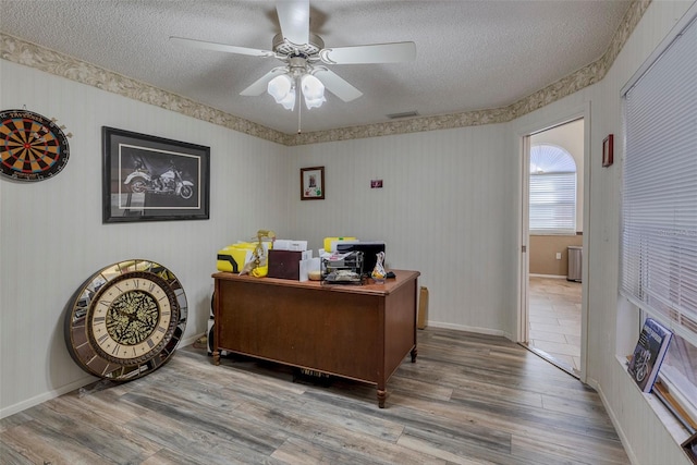 office area with a textured ceiling, hardwood / wood-style flooring, and ceiling fan