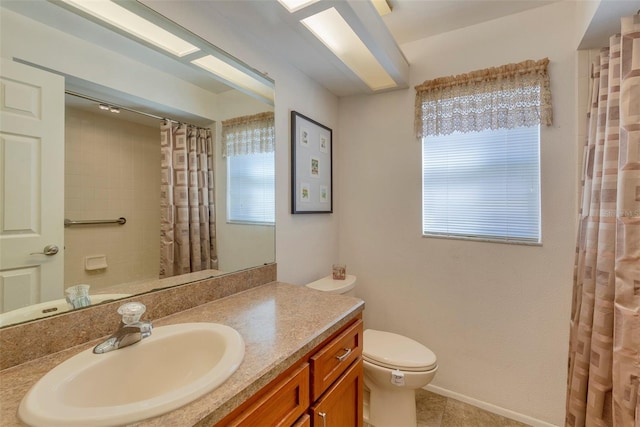 bathroom with toilet, vanity, tile patterned floors, and curtained shower