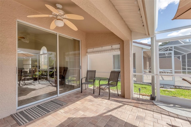 unfurnished sunroom featuring a wealth of natural light and ceiling fan