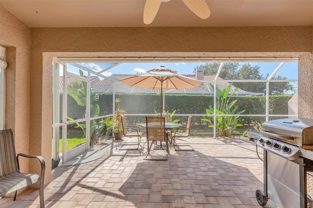 unfurnished sunroom with plenty of natural light and ceiling fan