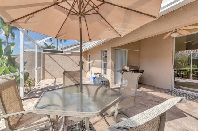 view of patio / terrace featuring grilling area, ceiling fan, and a lanai