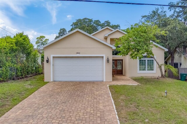 view of front of home featuring a garage and a front lawn