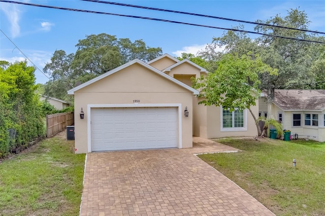 view of front of house with central AC unit, a garage, and a front yard