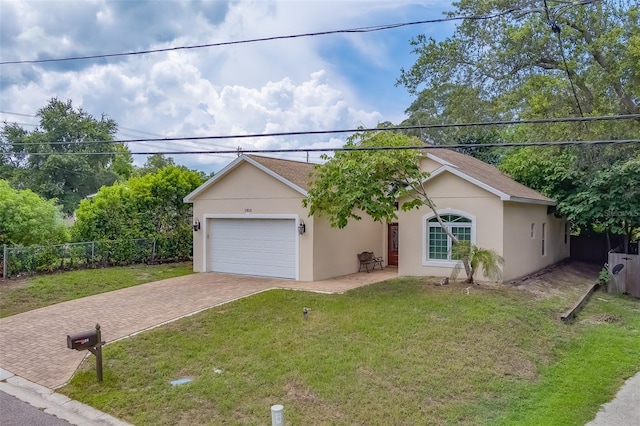 ranch-style house featuring a garage and a front yard