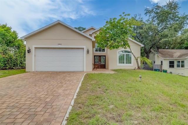 view of front of property with a garage and a front lawn