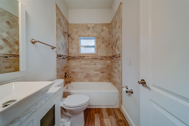 full bathroom featuring vanity, tiled shower / bath combo, toilet, and wood-type flooring