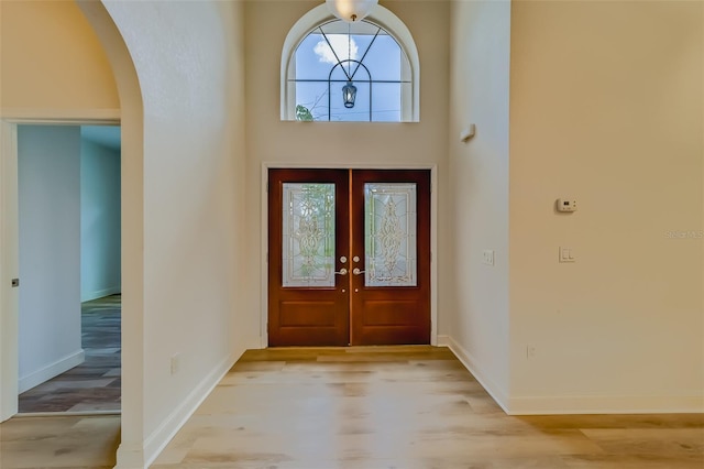 foyer entrance featuring french doors and light wood-type flooring