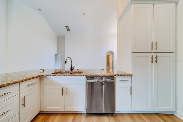 kitchen featuring dishwasher, light hardwood / wood-style flooring, light stone counters, and sink