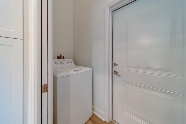 laundry room with light hardwood / wood-style floors and washer / dryer