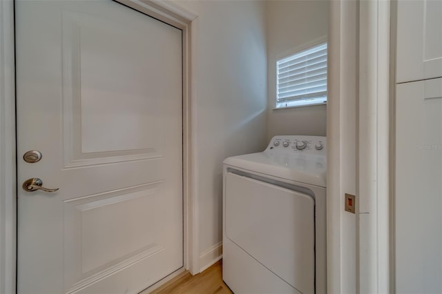 laundry area with washer / clothes dryer and light wood-type flooring