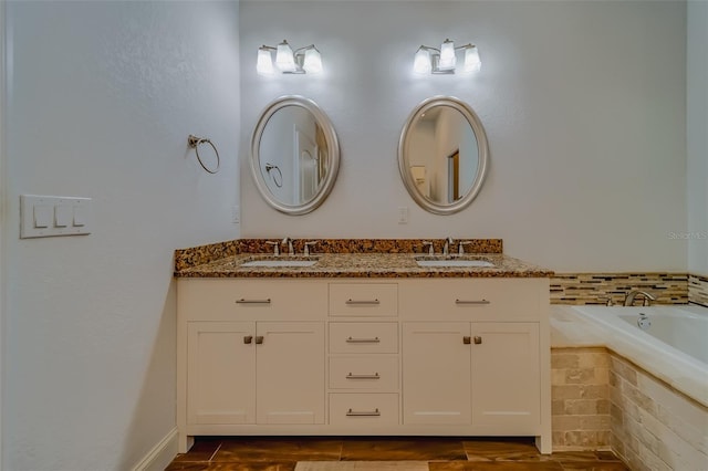 bathroom with tiled bath and double sink vanity