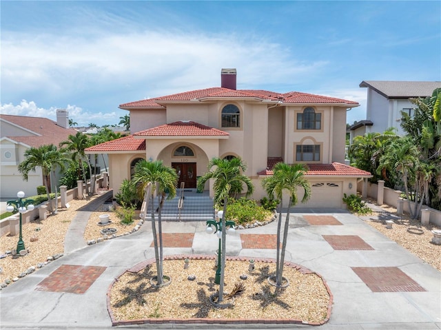 mediterranean / spanish house featuring a garage