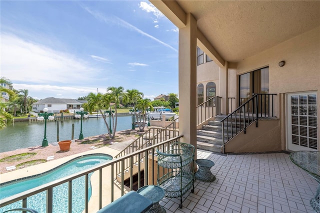 balcony featuring a patio, a water view, and a jacuzzi