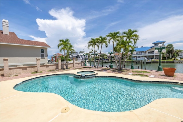 view of pool with a water view and an in ground hot tub