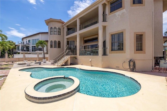 view of pool featuring an in ground hot tub