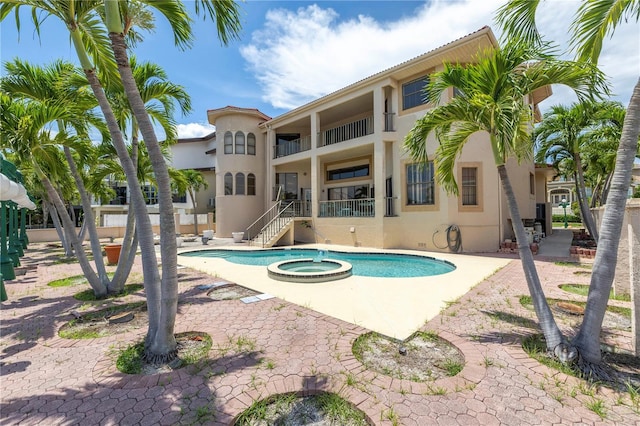 view of swimming pool featuring an in ground hot tub and a patio