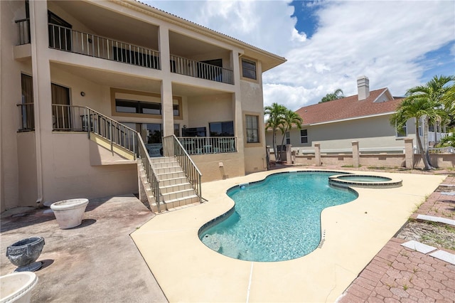 view of pool featuring an in ground hot tub and a patio area