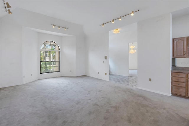 interior space with light carpet and rail lighting