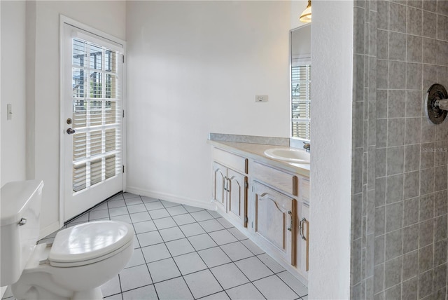 bathroom featuring vanity, tile patterned floors, and toilet