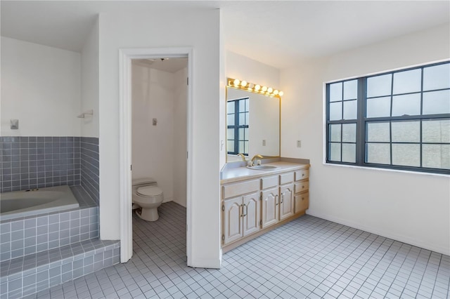 bathroom with vanity, plenty of natural light, tile patterned floors, and toilet