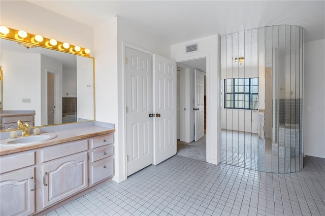 bathroom with tile patterned flooring and vanity