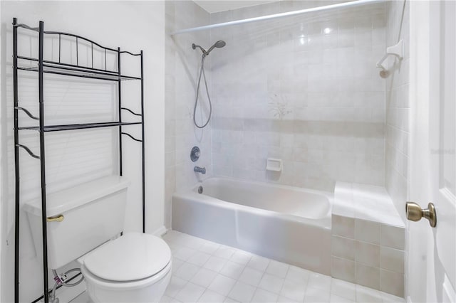 bathroom with tiled shower / bath combo and toilet