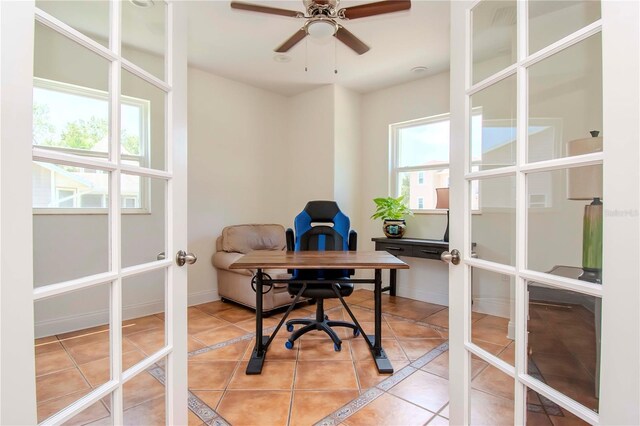 tiled office space with a healthy amount of sunlight, french doors, and ceiling fan