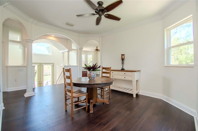 dining room featuring crown molding, dark hardwood / wood-style flooring, ornate columns, and ceiling fan