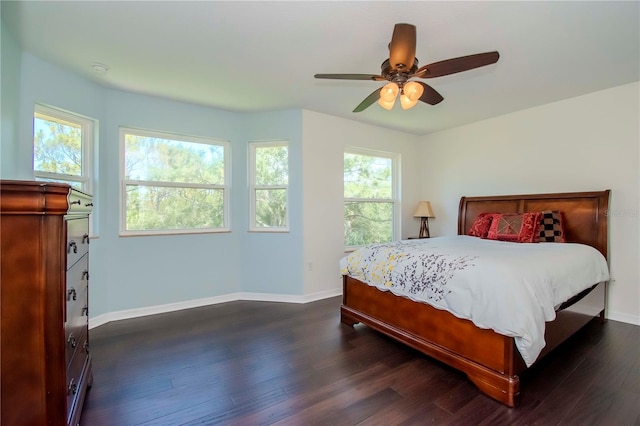 bedroom with dark hardwood / wood-style flooring and ceiling fan