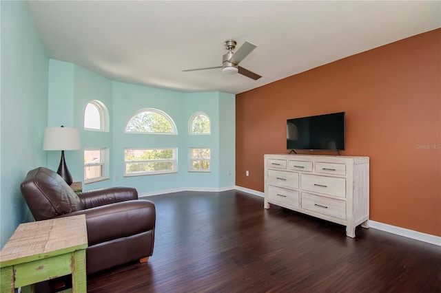 living room with dark wood-type flooring and ceiling fan