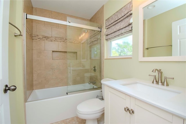 full bathroom with enclosed tub / shower combo, vanity, and toilet