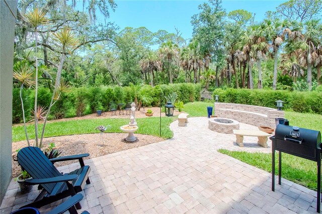 view of patio / terrace featuring an outdoor fire pit