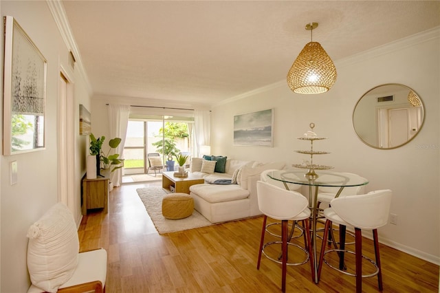 living room featuring hardwood / wood-style floors and ornamental molding