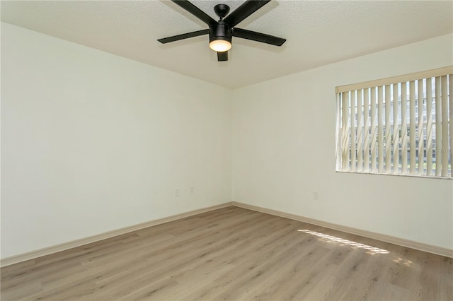 empty room with light hardwood / wood-style floors and ceiling fan