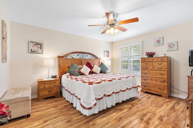 bedroom with ceiling fan and hardwood / wood-style flooring