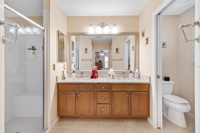 bathroom featuring toilet, tile patterned flooring, vanity, an enclosed shower, and ceiling fan