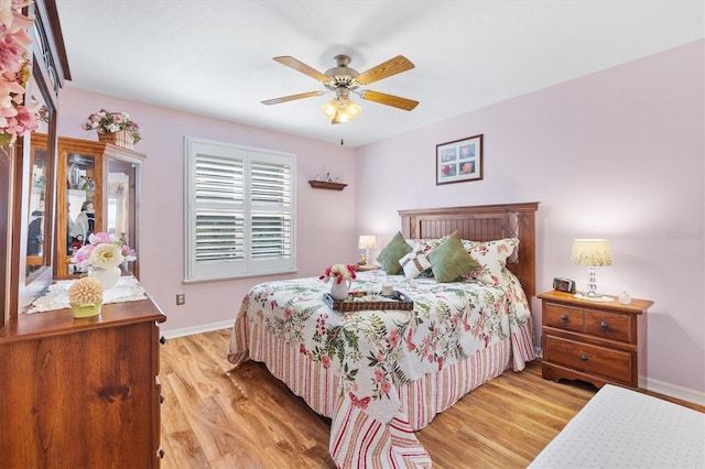 bedroom with light hardwood / wood-style floors and ceiling fan