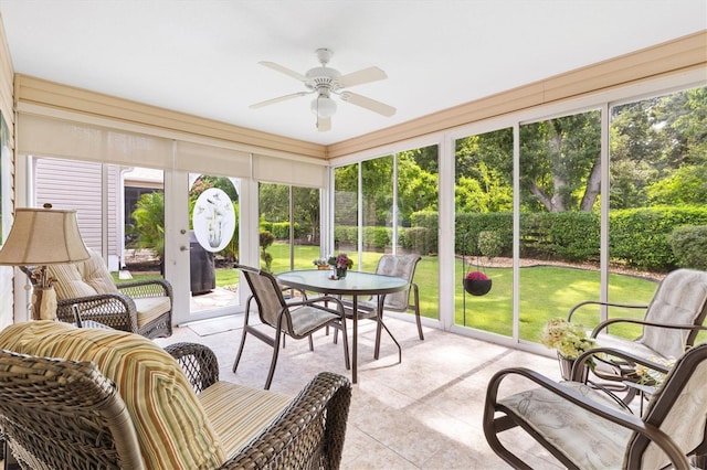 sunroom / solarium featuring ceiling fan