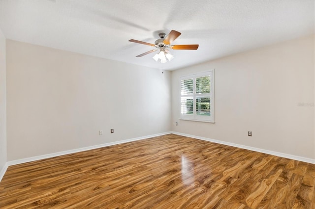 unfurnished room with hardwood / wood-style floors, a textured ceiling, and ceiling fan