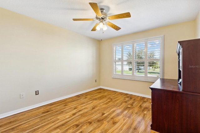 unfurnished office featuring light hardwood / wood-style floors and ceiling fan