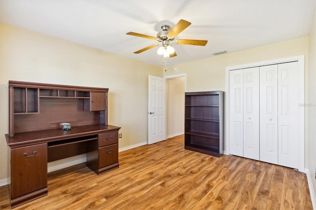 unfurnished office with light wood-type flooring and ceiling fan